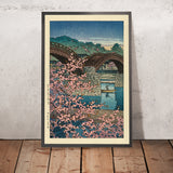 Flores de cerezo en la tarde de primavera en el puente Kintai por Hasui Kawase 1935 