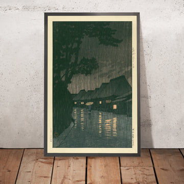Ein gerahmtes Bild von "Rainy Night in Maekawa" von Hasui Kawase, 1935